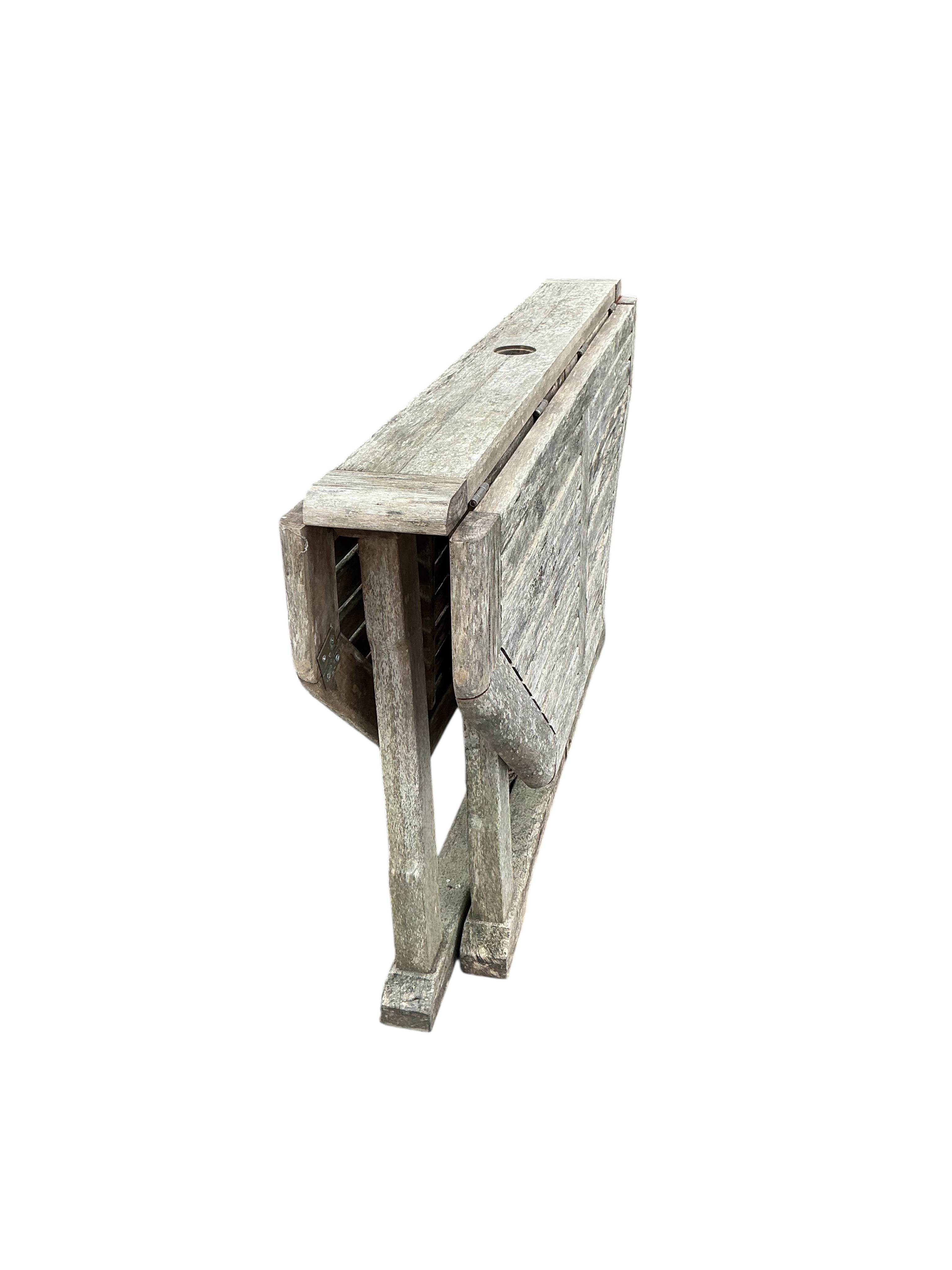 A weathered teak octagonal folding garden table, width 120cm, height 74cm